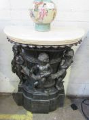 Console table of 3 bronzed cherubs round classic column with marble-effect top, 77 x 38 x 101cms.