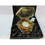 Gold plated gimbal mounted travel clock by Jens Olsen in original box. Estimate £40-60