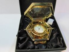 Gold plated gimbal mounted travel clock by Jens Olsen in original box. Estimate £40-60