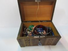Carved wooden box containing semi-precious stone set jewellery. Estimate £15-25