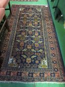 Dark orange & dark blue ground rug, 200 x 105cms. Estimate £20-30