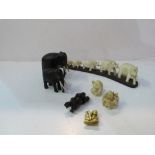 Family of carved bone elephants; carved ebony elephants; 3 Netsukis & a small carved figure.