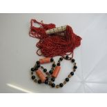 Coral coloured bead & bone necklace & a coral, black & brown bead necklace. Estimate £10-20