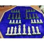 Carved stone chess set in case with chequer board top. Estimate £30-40
