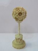 Asian ivory carved balls within balls, on carved stand. Estimate £80-100