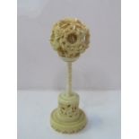 Asian ivory carved balls within balls, on carved stand. Estimate £80-100