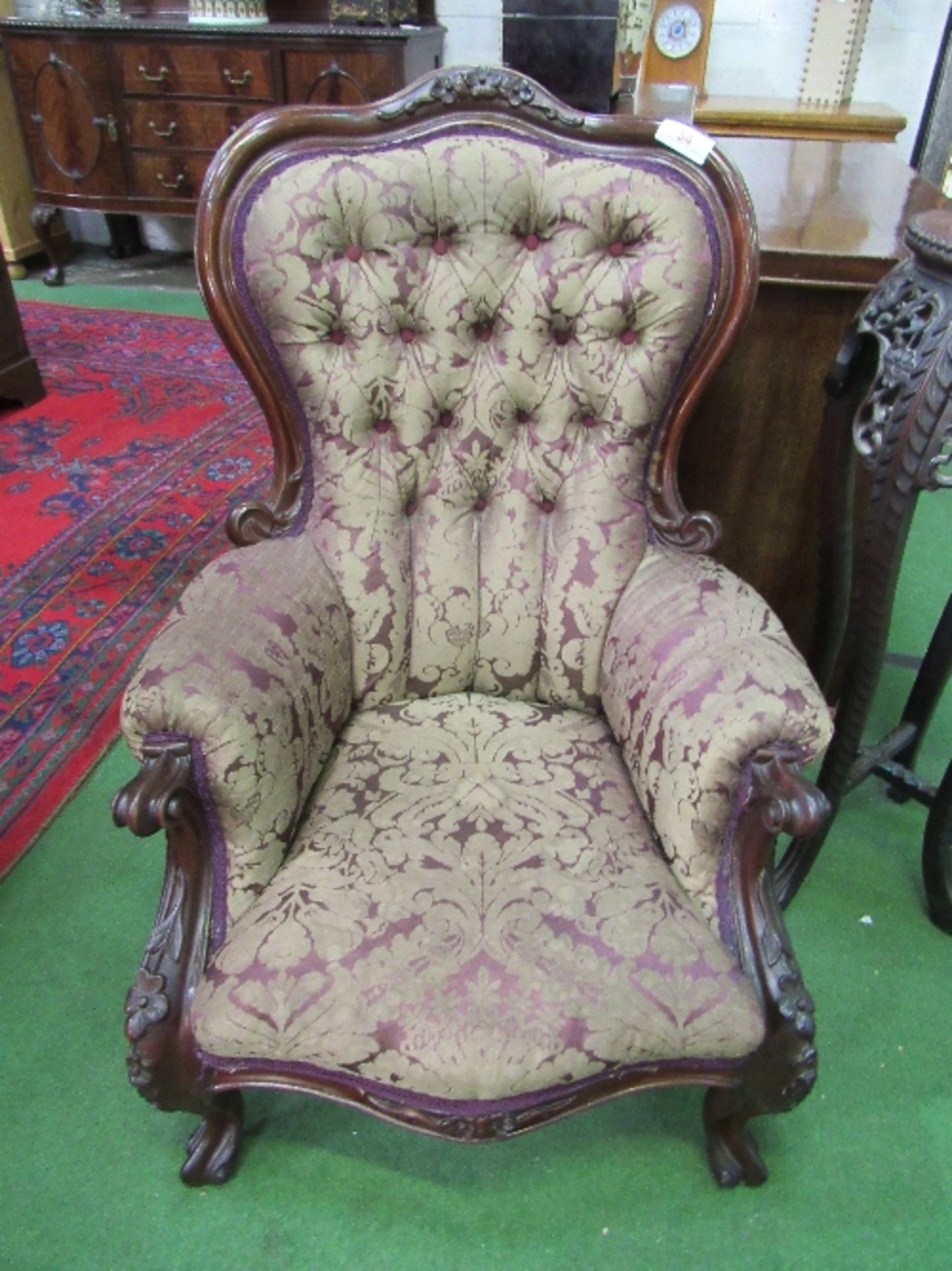 Victorian carved mahogany framed lady's armchair, upholstered in original button back fabric.