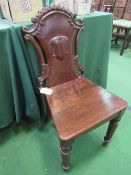 Mid-Victorian ornately carved dark oak hall chair. Estimate £40-50