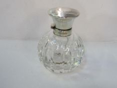2 cut crystal perfume bottles with silver hinged engine turned decorated lids. Estimate £90-