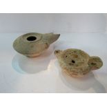 2 antiquarian clay oil lamps. Estimate £10-20