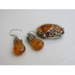 Silver mounted amber brooch & a pair of amber drop earrings. Estimate £30-50