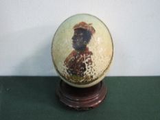 19th century hand-painted Ostrich egg depicting a Moorish Trader, on Chinese carved wood stand.