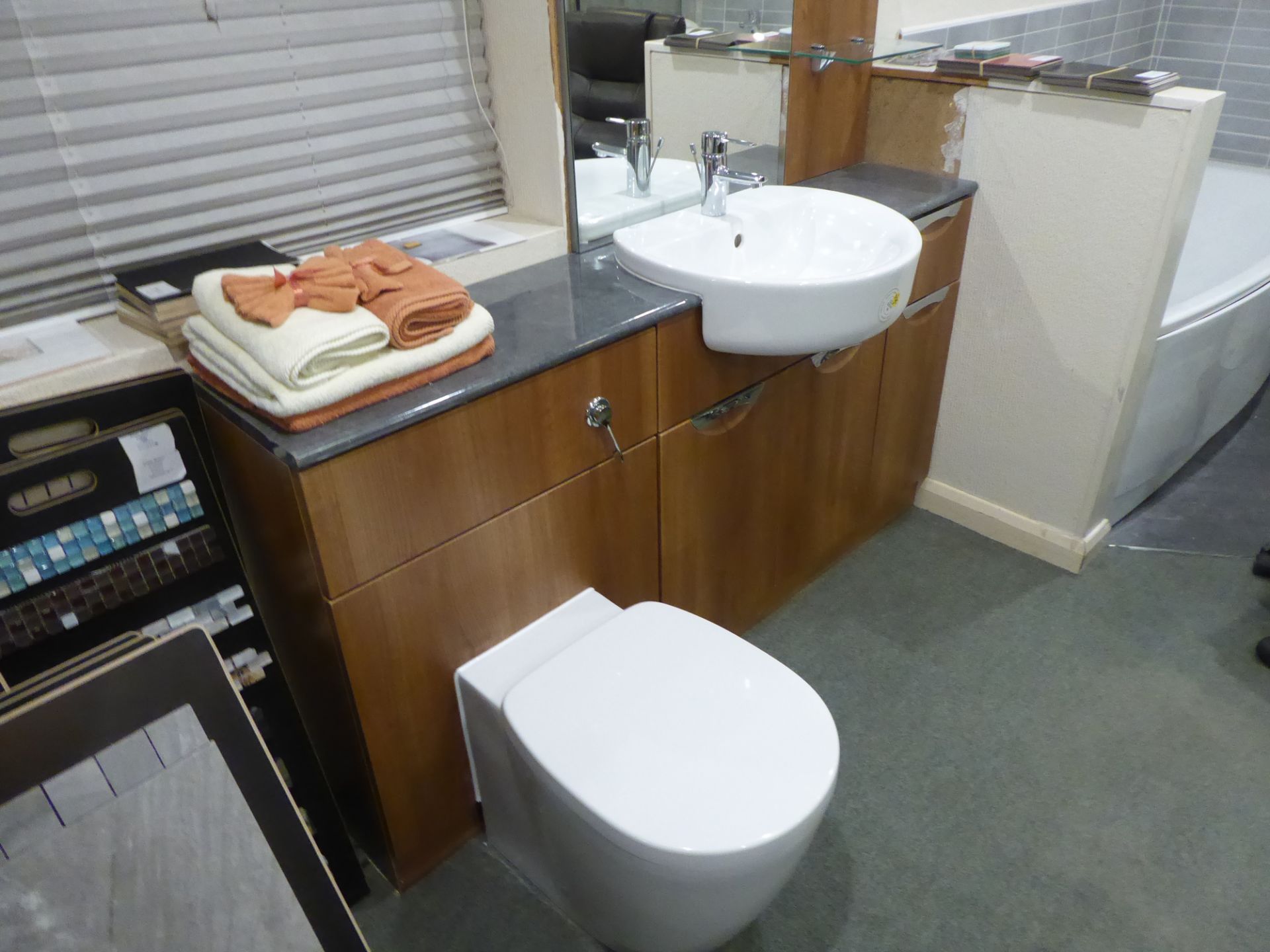 Semi counter top cloakroom in American Walnut with Ideal Standard Concept sphere basin and Aquablade