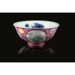 A ruby-ground sgraffiato medallion bowl decorated with landscape scenes, the interior in blue and