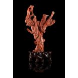 A red coral carving of a lady wearing long robes accompanied by a phoenix, wood baseChina, early