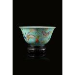 A turquoise-ground Famille Rose bowl decorated with butterflies amongst flowers and fruiting