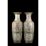 A pair of Cantonese Famille Rose vases decorated with figures and floral motifs (defects)China, half