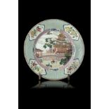 A Famille Rose porcelain dish, the centre decorated with a pavilion, the border with rich floral and