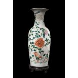 A Famille rose baluster vase decorated with floral motifs, wood baseChina, 20th century(h. 61 cm.)