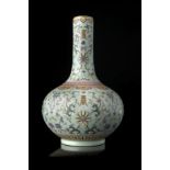 A celadon-ground Famille Rose porcelain bottle vase decorated with stylised lotus flowers and leaves