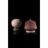 A small potiche and cover and a rounded small vesse all in monochrome-glazed porcelain, wood base (