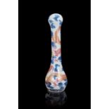 A blue and white and polychrome porcelain fly whisk handle decorated with dragons amongst clouds,