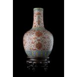 A porcelain vase decorated with floral and auspicious motifs on an orange-ground, wood baseChina,