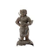 A bronze model of a warrior wearing an armor and standing on a base with clouds and a dragonChina,