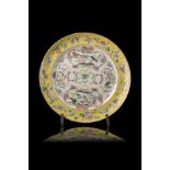 A yellow-ground Famille Rose dish decorated with birds, flowers and Buddhist parasols, with