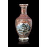 A polychrome enamels and iron-red vase decorated with a landscape scene, with apocryphal Qianlong