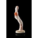 A pale pink coral carving of a lady wearing long robes, with a bone base (slight defects)China,