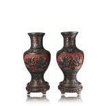 A pair of lacquer vases, the black carved floral decoration reserved on a cinnabar groundChina, 19th