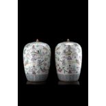 A pair of Famille Rose ovoid vases and covers decorated with the 'hundred antiques' (defects)