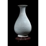A celadon-glazed yuhuchunping porcelain vase carved in low relief with lotus flowers and scrolls,