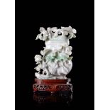 A jadeite vase, carved with flowering branches, the stone with apple-green veins, wood baseChina,