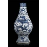 A blue and white Ming-style vase decorated with a winged dragon amongst clouds, a phoenix and