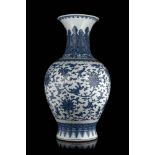 A large blue and white baluster vase decorated with stylised lotus flowers and scrolling leaves