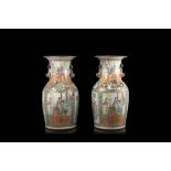 A pair of Cantonese Famille Rose vases decorated with figures in interior scenes (defects)China,