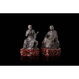 A pair of bronze model of Buddhist monks, with wood bases, with inscriptions mentioning the Buddhist
