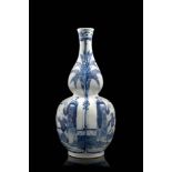 A double gourd porcelain vase decorated in blue and white with ladies and boys, with an apocryphal
