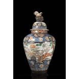 A large polychrome enamel vase and cover decorated with mythical creatures, the cover with a