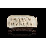 An ivory plaque carved in relief with boys, wood supportChina, 19th century(l. 17 cm.)This lot may