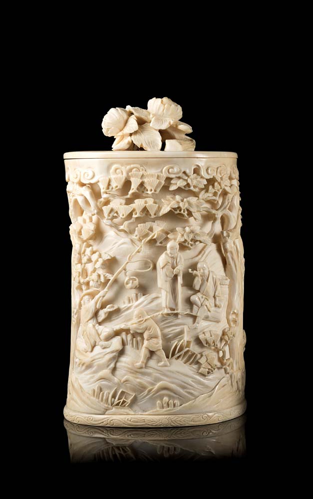 An ivory cylindrical box and cover carved and pierced with a landscape scene and floral motifsJapan,