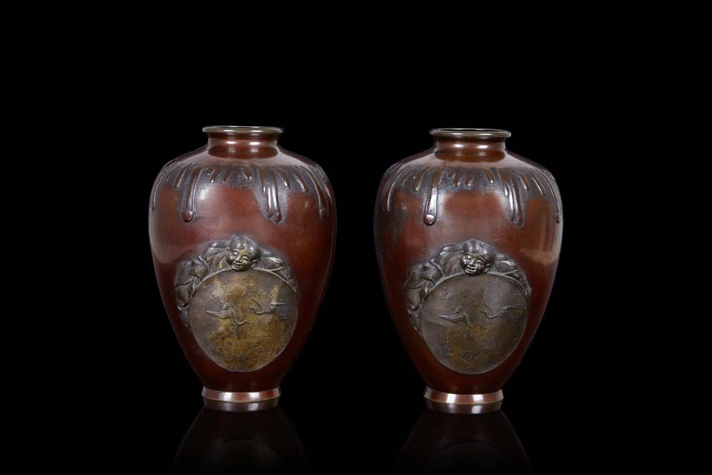 A pair of bronze vases decorated with applied boys (slight defects)Japan, Meiji period (1868-1912)(