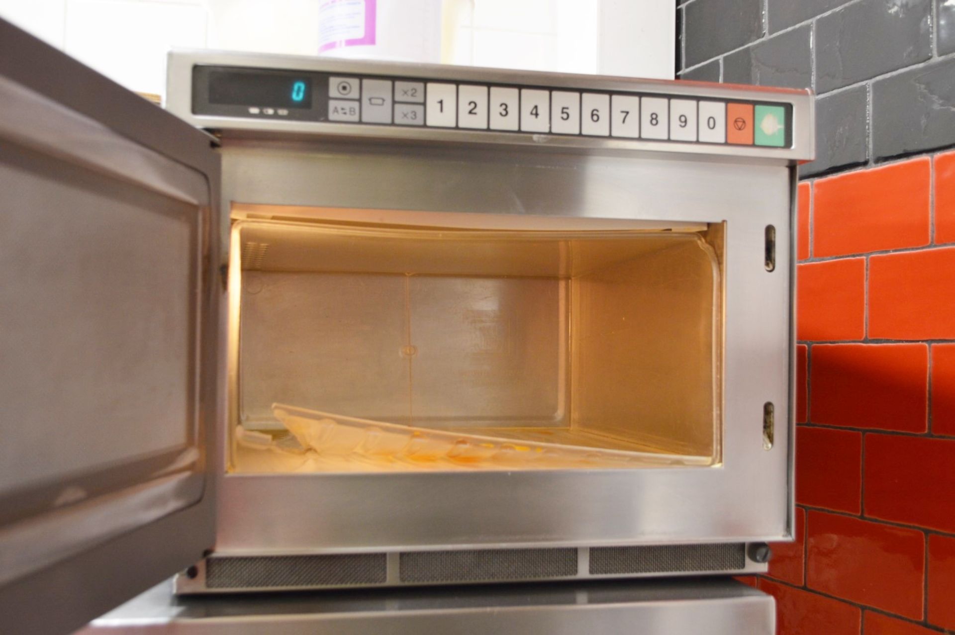 1 x Panasonic Commercial Microwave Oven With Stainless Steel Exterior and Wall Mounted Shelf - Ref - Image 3 of 3