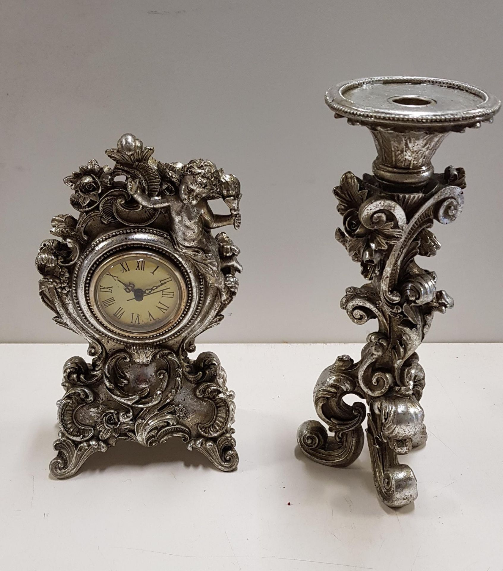 Silver coloured vintage style fancy clock & candlestick