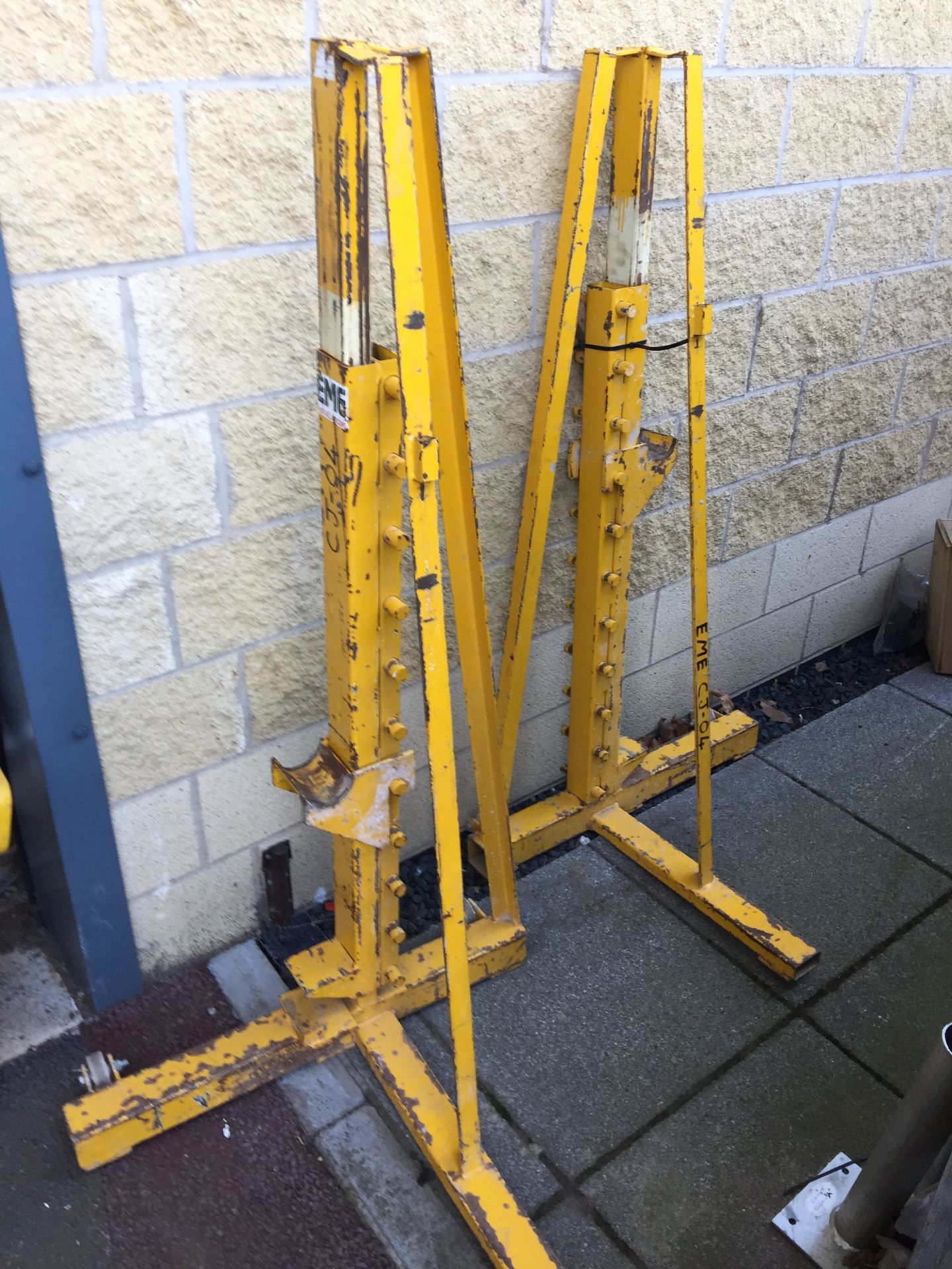 A pair of large yellow reel winding stands