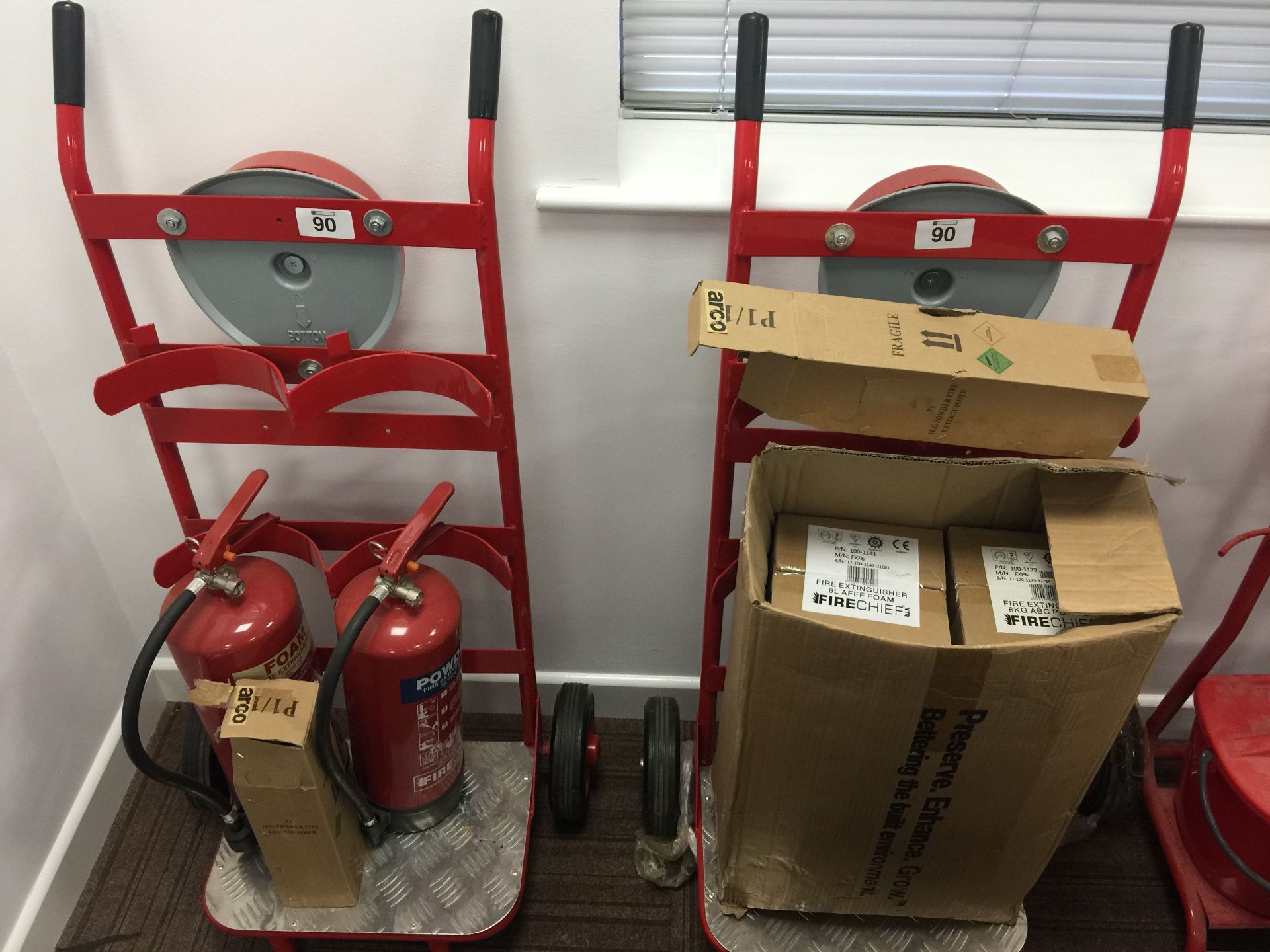 2 x Double fire extinguisher trolleys with bell and extinguishers