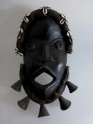 Maske, Afrika, wohl Dan oder We - Elfenbeinküste, Holz geschnitzt, am KieferBronzeglocken, Stirn mit