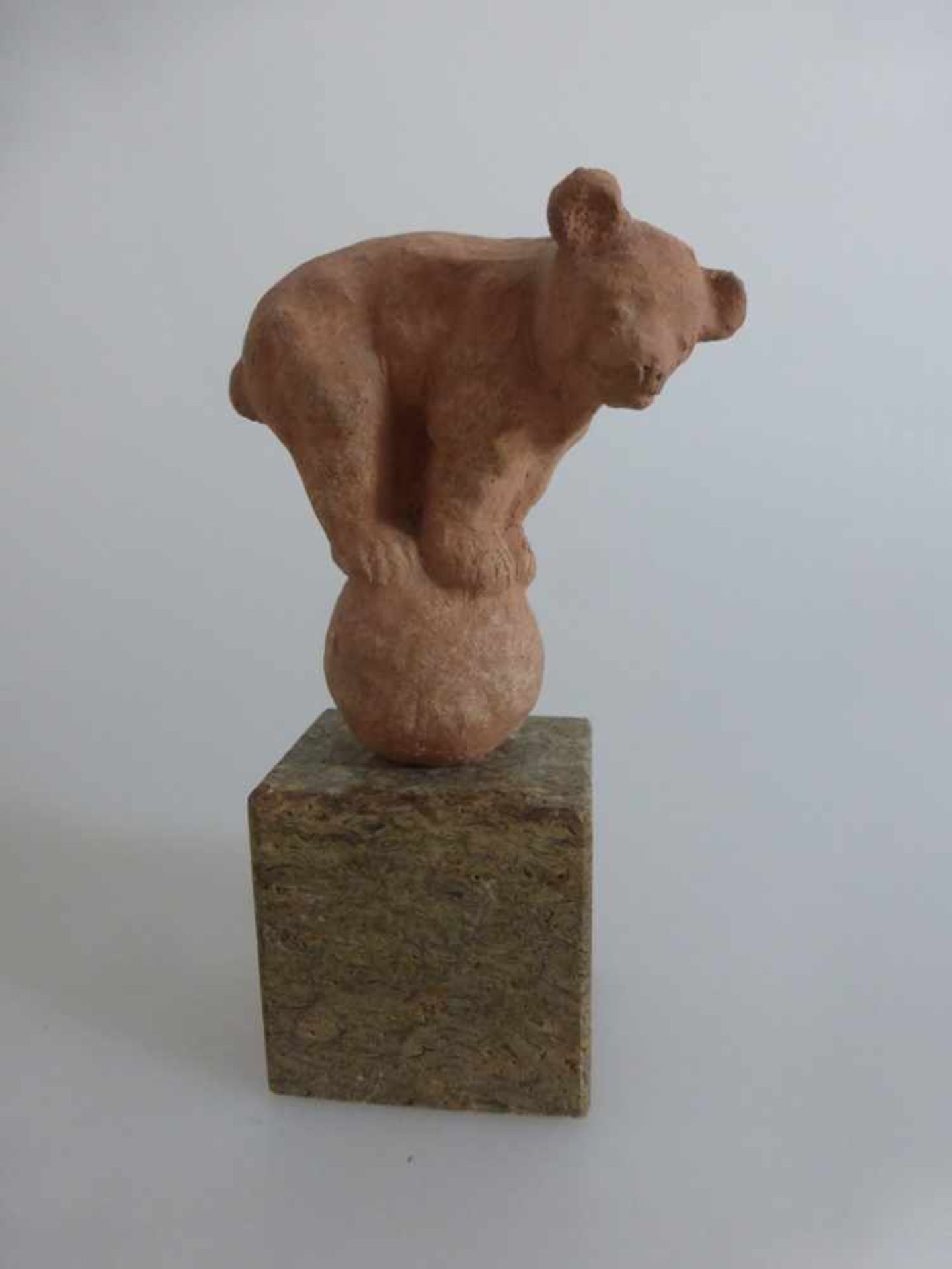 Kleine Tierskulptur, Bär auf Kugel, Ton, auf Marmorsockel, h. m. Sockel 13cm, dieDarstellung